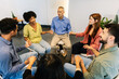 © Xavier Lorenzo - Diverse individuals sitting in a circle, holding hands, and sharing experiences during a therapy session, promoting community, empathy, and emotional well-being