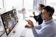 © fizkes - Contact centre specialists at work. Professional multiethnic team support employees service consultants in headsets manage video conference calls in online app interact with diverse persons on screens