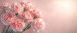 © btiger - cluster of pale pink carnations with green stems on a soft glowing pastel background evoking gentle romantic serenity and delicate elegance