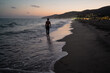 © Cavan - Young blond muscular man walking barefoot on beach at dusk