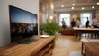 © Bussakon - A sleek modern television displays a city skyline at dusk in a contemporary lounge area with people gathered in the background