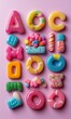© Gadis - Colorful candy assortment arranged in rows on pink background.