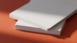 © Fadhil - Blank Printing Paper Sheets on Orange Background