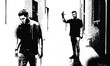 © Md - Black and white urban street scene with anonymous men walking in alley, gritty stencil style vector illustrationBlack and white urban street scene with anonymous men walking in alley, gritty stencil s