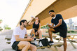 © ADDICTIVE STOCK - Multiethnic group of friends takes a break from urban sports