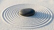 © Omishu Makes - Smooth black zen stone resting on raked white sand with circular patterns, mindfulness and harmony concept.