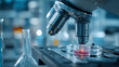 © Jhati - A microscope examines a petri dish in a laboratory setting with various scientific equipment