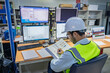 © reewungjunerr - Engineer computer worker on High-performance computers with a lot of monitor in large factory,Control the operation of large machines,Write a program to run the robot,Programmer working with serious