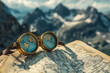 © Daisy Heart - Vintage explorer goggles with world map on travel map background and mountain landscape