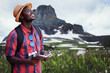 © arrowsmith2 - Happy African Traveler Journaling and Exploring Scenic Mountain Landscape