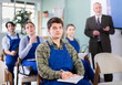 © JackF - Interested young male student in blue overalls attending technical seminar with a teacher