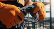 © DesignAIPro - Worker's hands in orange gloves holding a climbing carabiner