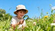 © Kelvin - Child exploring flowers with magnifying glass