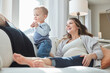 © peopleimages.com - Mom, pregnancy or laughing with toddler on sofa in home for fun childhood or parenthood together. Happy, pregnant woman and playful son with smile for maternity, growth development or youth in house