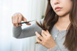 © KMPZZZ - Hair problem person, frustrated asian young woman, girl use scissors to trim off the damaged of hair, heat damage and dry hair, split ends and hair texture thinning. Healthcare of beauty concept.