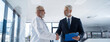 © Halfpoint - Portrait of manager shaking hand with doctor. Banner with copy space.