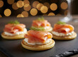 © Jim - Smoked salmon appetizers arranged on slate. Small cornbread cakes topped with cream cheese, salmon, and dill. Cozy bokeh lights add festive atmosphere for parties or events. Gourmet Party Appetizers