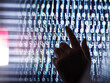 © Westend61 - Cropped image of human hand touching computer screen