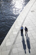 © Westend61 - Two businessmen walking and talking at the riverbank