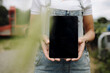 © Westend61 - Woman showing blank tablet screen