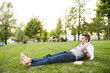 © Westend61 - Mature businessman in the city park lying on grass