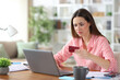 © Antonioguillem - Disappointed freelance worker buying online checking laptop