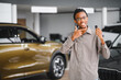 © Serhii - Happy african american man showing the key of his new car