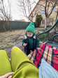© phpetrunina14 - Toddler in Green Hat by Swing Bench in Backyard Portrait
