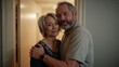 © Future Vision - Embracing senior couple in home doorway, wearing beige polo and floral top, showing smartwatch