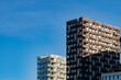 © yaqui_villegas - Daylight skyline of modern residential apartment buildings in Bjorvika Oslo with contemporary architecture rising above the city under clear blue sky