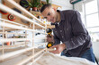 © ReeldealHD images - Young man using a screw driver to repair a piece of furniture