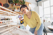 © ReeldealHD images - Young Woman Assembling a piece of flat pack furniture at home