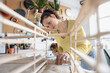 © ReeldealHD images - Young woman using a screwdriver to repair a piece of furniture