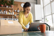 © ReeldealHD images - Focused Woman getting a parcel ready to ship