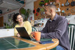© ReeldealHD images - Smiling couple exploring ideas on their devices