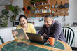 © ReeldealHD images - Friends studying together using technology in their kitchen