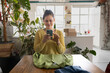 © ReeldealHD images - Smiling Woman taking a photo of clothing to sell online