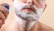 © splitov27 - Man's face with shaving foam on a beige background
