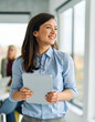 © Lumos sp - Portrait of a group of young business people having a meeting or training in the office. Teamwork and success concept, portrait of a smart young businesswoman, student, teacher or coach holding a tabl