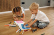 © standret - Process of drawing. Little kids are playing together in the domestic room at daytime