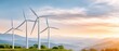 © Luiri Art - Wind turbines generating renewable energy on mountain landscape at sunrise with large sky copy space