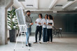 © standret - Explaining the problem with a project. Four office workers are together, employees at work