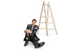 © Ljupco Smokovski - Man in a torn suit with leg injury sitting on the floor next to a ladder