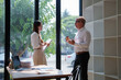 © Tj - Business people discussing plans during office brainstorming session