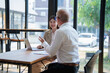 © Tj - Business people having informal meeting at cafe table