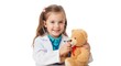 © Deamard - A cheerful young girl with twin tails playing doctor, examining her plush teddy bear with a stethoscope, white background.