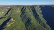 © bydronevideos - Southern Canyons In Praia Grande Santa Catarina Brazil. Cliffside Surrounded By Lush Green Forest Viewed From Above. Countryside Dramatic Sky Rural Field. Countryside Horizon.