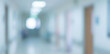 © birulaut - A blurred interior view of a hospital corridor, featuring soft lighting and neutral colors, conveying a sense of calm and cleanliness in a healthcare environment.