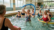© logonv - Senior woman group doing water aerobics in indoor pool with foam noodle. Happy retiree exercising during aqua fitness class. Active lifestyle and sport health concept for elderly aged.