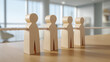 © INSPIRIA.K - Wooden human figurines connected by a rope representing a network. Concept of team unity through social connection. Business collaboration and cooperation in modern professional environment.